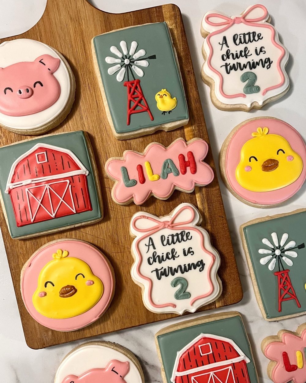 Farm birthday cookies with chicks, pigs, barns and a little chick is turning 2